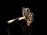 a close up of a diamond ring on a black surface