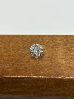 a close up of a diamond on a wooden table