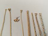 a lot of gold necklaces and bracelets on the table