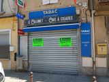 une voiture garée devant un immeuble sur laquelle sont apposées des affiches