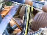 a reflection of a woman in the back seat of a car