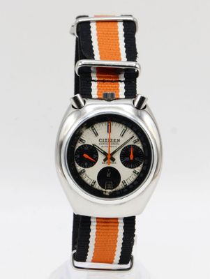 an orange and white watch with a black and white stripe strap