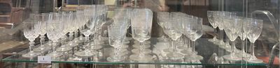 many glasses of champagne on display in a glass case