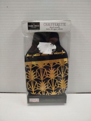 a close up of a black and gold tissue holder in a package