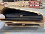 two laptops in a cardboard box on a pallet