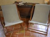 two chairs that are sitting on a tile floor