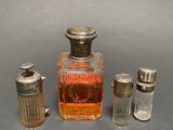 three bottles of perfume sitting next to each other on a table