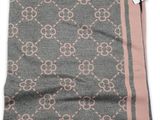 a grey and pink scarf with a pink stripe on it