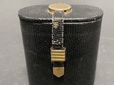 an image of a black and gold box with a chain around it
