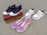 trois paires de chaussures d'enfants posées sur une boîte