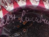 a close up of a red and white vase with writing on it