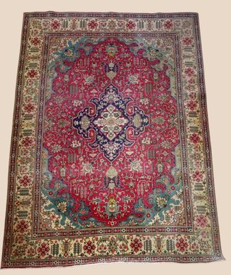a red and blue rug with a medallion design on it