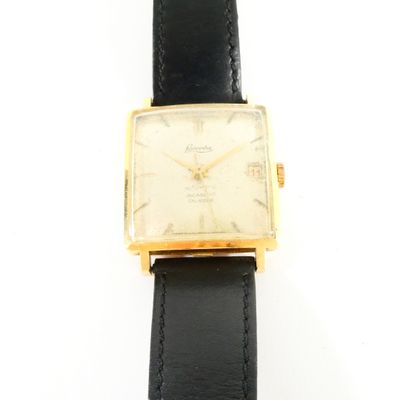 an image of a gold plated wrist watch with a black leather strap