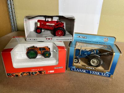 three toy vehicles in the boxes on the table