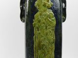 a blue vase with a green design on it