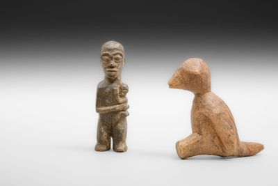 deux petites figurines représentant un homme et un chien