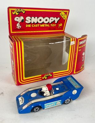 a blue toy car in front of a red box