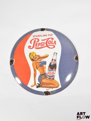 a picture of a pepsi cola sign on a wall