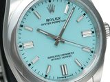a rolex watch with a blue dial on it