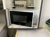 a microwave sitting on top of a counter in a kitchen