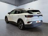 the rear end of a white volkswagen suv parked in a garage
