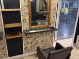 an image of a salon with a chair and a mirror