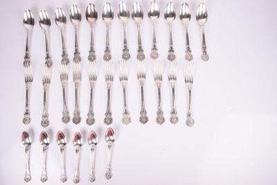 a lot of silver spoons and spoons on a table