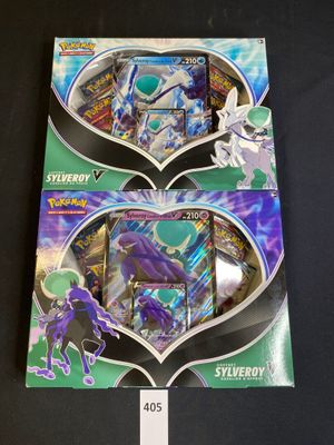 two packs of pokemon trading cards are on display in a box