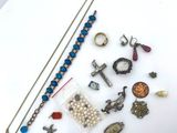 a white plate with a bunch of jewelry on it