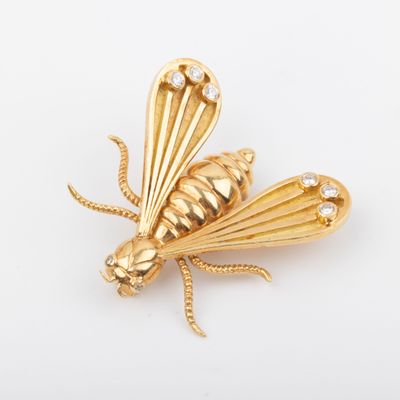 an image of a gold insect brooch with diamonds on it
