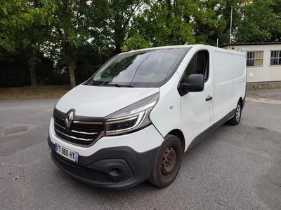 the white van is parked in a parking lot with trees in the background