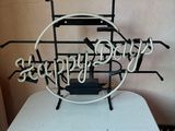 a metal sign that says happy birthday on a table