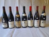 several bottles of wine are lined up on a table