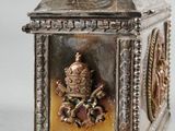a silver and gold clock with a clock face on it
