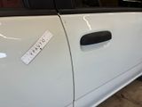 a sticker on the door of a white car