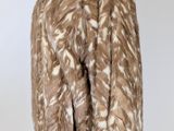an image of a brown and white fur jacket on a mannequin stand