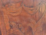 a wooden chair with carvings on the back of it