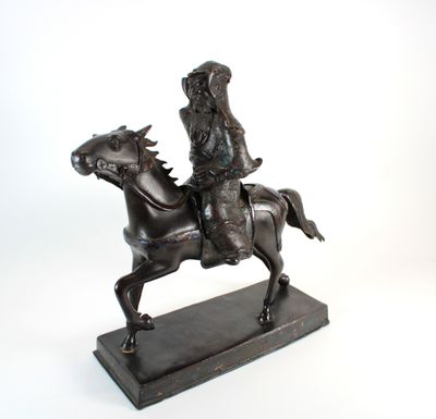 bronze statue of a man riding a horse on a white background