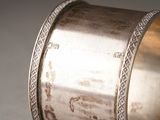 a close up of a silver ring on a table