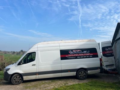 a white van that is parked in front of a building