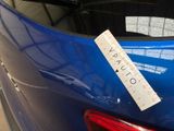 a sticker on the back of a blue car