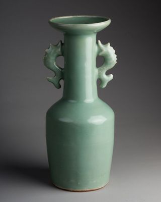 green vase with two seahorses on the handle