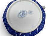 a blue and white bowl on a white surface