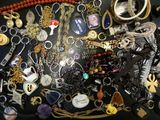 many different types of necklaces on a black table