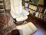 an image of a living room with a chair and bookshelf