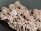 a close up of a piece of rock with white crystals on it