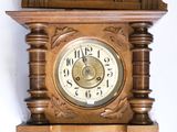a wooden clock on the wall with a bird on it