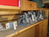 many pieces of metal sitting on a shelf in a room