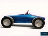 a blue toy car that is sitting on a white surface