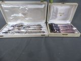 two silverware items in a case on a table